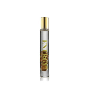 Energy Rollerball | Aluminate Life in a clear glass bottle with gold lettering and a gold cap, containing visible dried botanicals inside for wellness and body care.