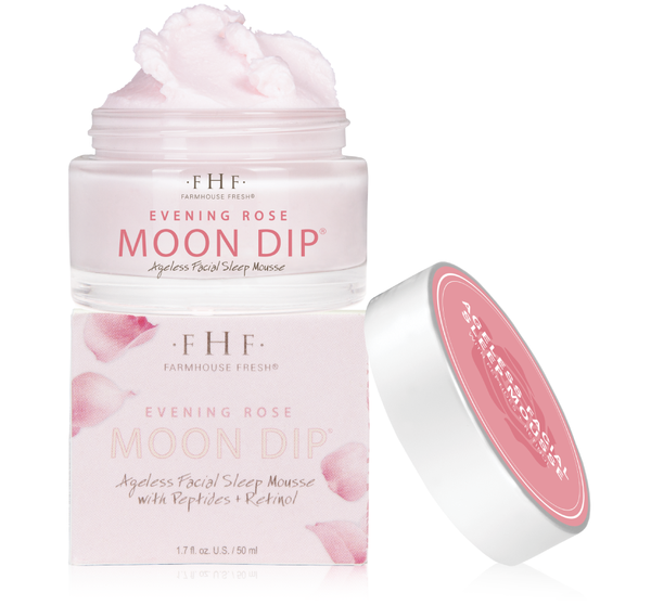 Open jar of Evening Rose Moon Dip® Ageless Facial Sleep Mousse with Peptides + Retinol | Farmhouse Fresh showing soft pink mousse texture next to its decorative box and lid.