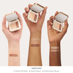 Three diverse skin tones showing swatches of Purepressed Eye Shadow Triple | Jane Iredale in shades Matte Off White, Matte Peach, and Matte Warm Brown on their inner forearms.
