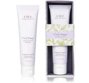 Two white tubes of Fluffy Bunny® Shea Butter Hand Cream | Farmhouse Fresh, one displayed outside and one inside a decorative box with green leaf and flower patterns.