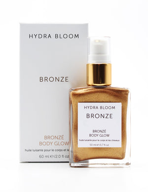 Bronze Body Glow | Hydra Bloom bottle with shimmering bronze liquid and white packaging, designed for skincare and body care providing a radiant glow.