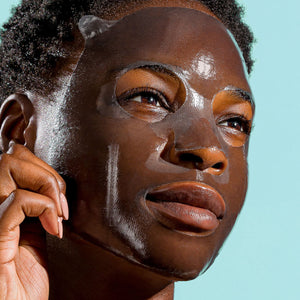 Close-up of a person wearing a clear hydrating facial sheet mask, demonstrating skincare and wellness with the I MASK hydrating hydrogel sheet mask (5 pack) | IMAGE Skincare.