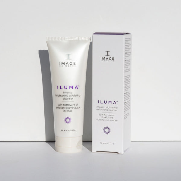 Tube and box of ILUMA intense brightening exfoliating cleanser | IMAGE Skincare displayed on a white surface with soft shadows, emphasizing skincare and wellness.