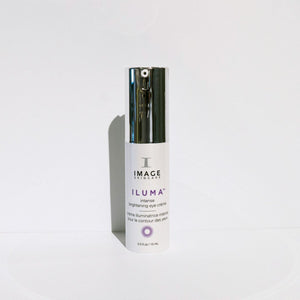 Bottle of ILUMA intense brightening eye crème | IMAGE Skincare, a white skincare product with a silver cap designed for eye care and brightening.