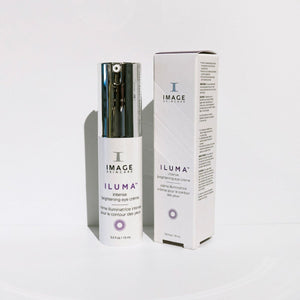 ILUMA intense brightening eye crème | IMAGE Skincare in a white bottle with a silver pump next to its matching box, both designed for skincare and brightening the eye area.