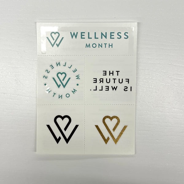 Sheet of Wellness Month Tattoos | Wellness Month with heart and wellness-themed designs in teal, black, and gold glitter on a light background.