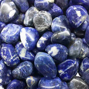 Close-up of polished blue and white semi-precious stones arranged together, conveying a calming and natural aesthetic for the Calm Essential Oil Vial | Aluminate Life.