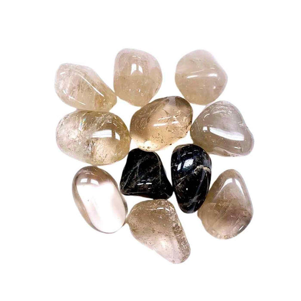 Collection of smooth, polished stones in shades of light brown and black, used as a wellness recovery tool for the Defense RollerBall | Aluminate Life.