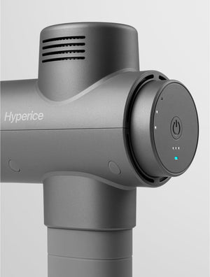 Close-up of the power button and control interface on a gray Hypervolt 2 | Hyperice massage device designed for body care and muscle recovery.