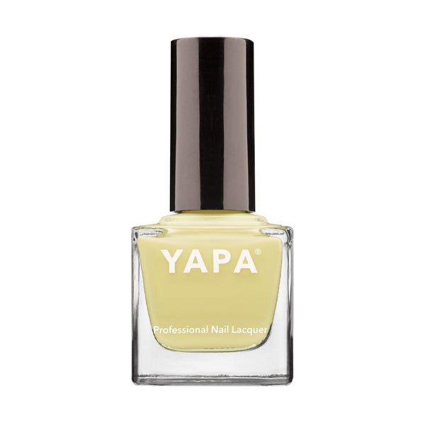 Jasmine Nail Lacquer | YAPA in a pale yellow shade with a sleek black cap, presented in a clear square glass bottle for professional nail care.