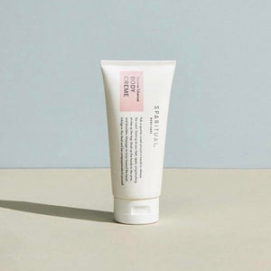 A minimalist tube of Jasmine Tuberose BODY CRÈME | Sparitual standing on a neutral surface with soft natural lighting, highlighting skincare and body care wellness.
