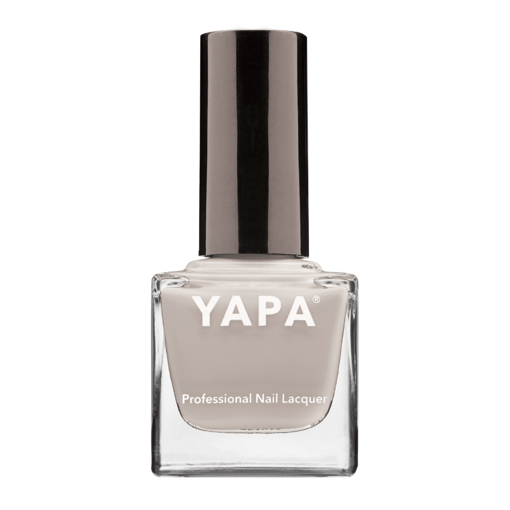 Michelle Nail Lacquer | YAPA in a sleek glass bottle with a neutral beige shade and a shiny black cap, designed for professional nail care and polish application.