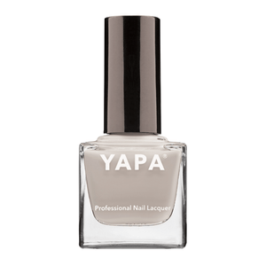Michelle Nail Lacquer | YAPA in a sleek glass bottle with a neutral beige shade and a shiny black cap, designed for professional nail care and polish application.