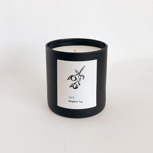 Minimalist black candle jar with a simple white label featuring an olive branch illustration, showcasing the No. 3 Bungalow Nap (Fiji) Candle | Lucky Owl.