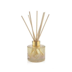 Sleep Reed Diffuser | Aluminate Life featuring a clear glass container with rose quartz crystals inside and natural reed sticks for a calming wellness atmosphere.