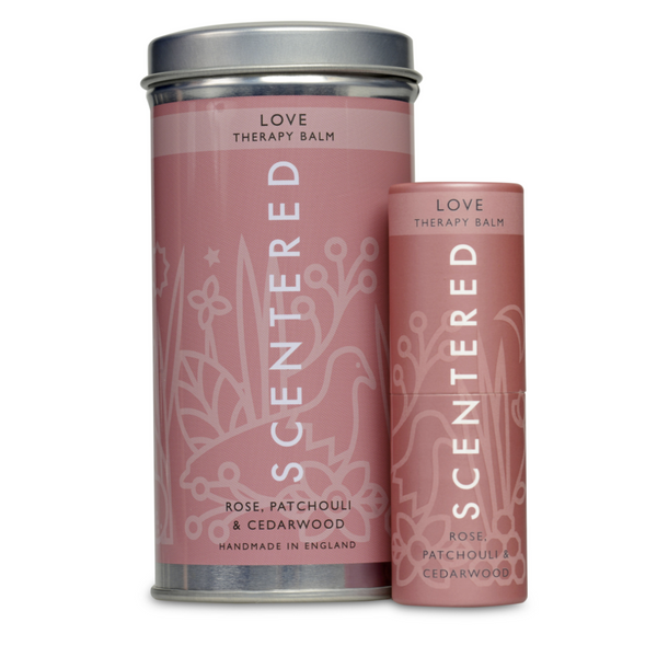 Two pink containers of Love Therapy Balm | Scentered with rose, patchouli, and cedarwood, designed for skincare and wellness in elegant packaging.