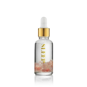 Clear glass vial filled with pink crystals and transparent liquid, topped with a gold dropper cap, labeled Sleep Essential Oil Vial | Aluminate Life for wellness and relaxation.