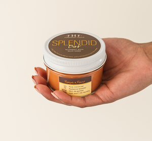 Hand holding a jar of Splendid Dirt® Nutrient Mud Mask with Organic Pumpkin Puree | Farmhouse Fresh, featuring pumpkin puree and labeled benefits for skincare.
