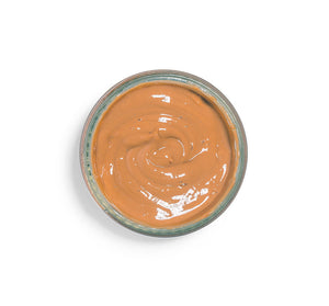 Top view of creamy texture in a jar of Splendid Dirt® Nutrient Mud Mask with Organic Pumpkin Puree | Farmhouse Fresh, a skincare product for nourishing and revitalizing skin.