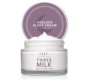 Open jar of Three Milk Ageless Sleep Cream with Peptides | Farmhouse Fresh showing smooth white skincare cream inside and purple lid with product name and crescent moon design.