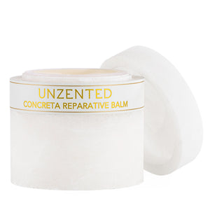 Open jar of Concreta | Zents reparative balm with white packaging and gold lettering, designed for skincare and body care wellness.