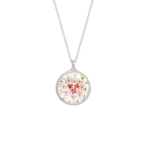 Small Ombre Botanical Necklace | Catherine Weitzman Jewelry featuring delicate pink and white floral elements encased in a round pendant on a silver chain.
