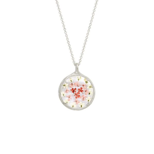 Small Ombre Botanical Necklace | Catherine Weitzman Jewelry featuring delicate pink and white floral elements encased in a round pendant on a silver chain.