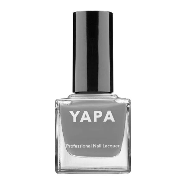 Bottle of Heather Nail Lacquer | YAPA in a muted gray shade with a black cap, labeled as professional nail lacquer.