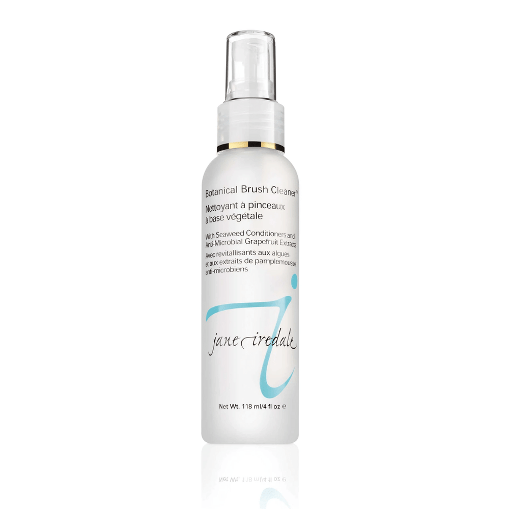 White spray bottle of Botanical Brush Cleaner™ | Jane Iredale with light blue logo and text highlighting seaweed conditioners and grapefruit extract for brush cleansing and skincare maintenance.