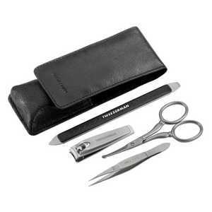 Essential Grooming Kit | Tweezerman featuring a black carrying case, nail clippers, tweezers, scissors, and a double-ended metal nail file for precise grooming and skincare.