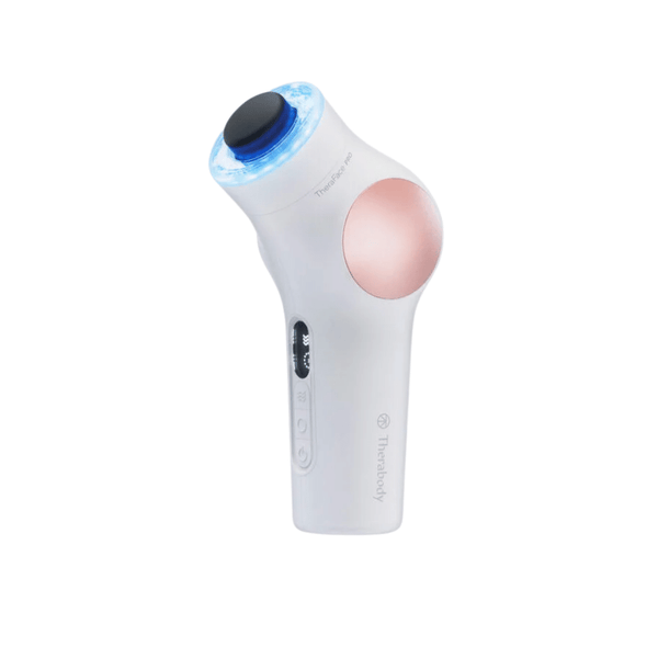 TheraFace PRO | Therabody handheld wellness device with a white body, rose gold accent, and a blue light ring designed for skincare and body care treatments.