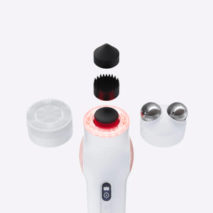 TheraFace PRO | Therabody skincare device with interchangeable attachments including a silicone brush, metal massage rollers, and a textured black applicator for facial care and wellness.