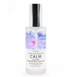 Clear spray bottle featuring a lavender floral design on the label, displaying "Hydra Bloom Calm Lavender Face and Body Mist | Hydra Bloom," ideal for skincare and body care routines.