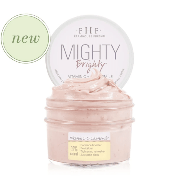 Open jar of Mighty Brighty™ Vitamin C + Chamomile Brightening Mask | Farmhouse Fresh showing creamy light pink skincare mask with product lid behind it and a green circle labeled new.