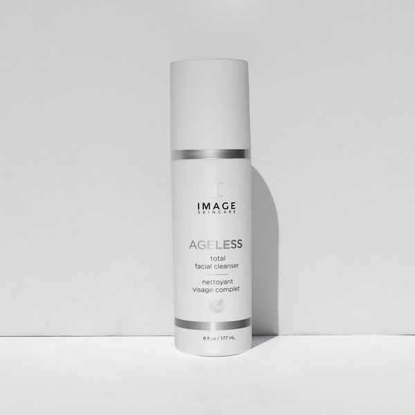 Bottle of AGELESS total facial cleanser | IMAGE Skincare, a white skincare product container with silver accents designed for a complete facial cleansing routine.