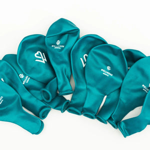A group of teal-colored Wellness Month Logo Balloon | Wellness Month balloons arranged on a white background, each featuring a white wellness-themed logo.