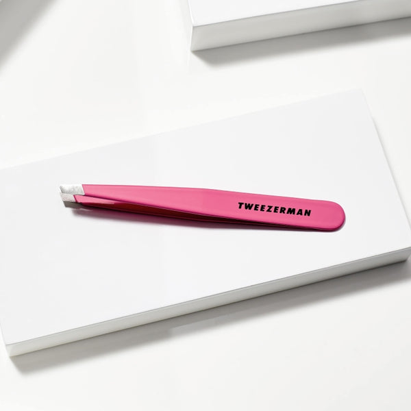 Slant Tweezer | Tweezerman in bright pink with precision angled tips, designed for accurate hair removal and perfect grooming in skincare and wellness routines.